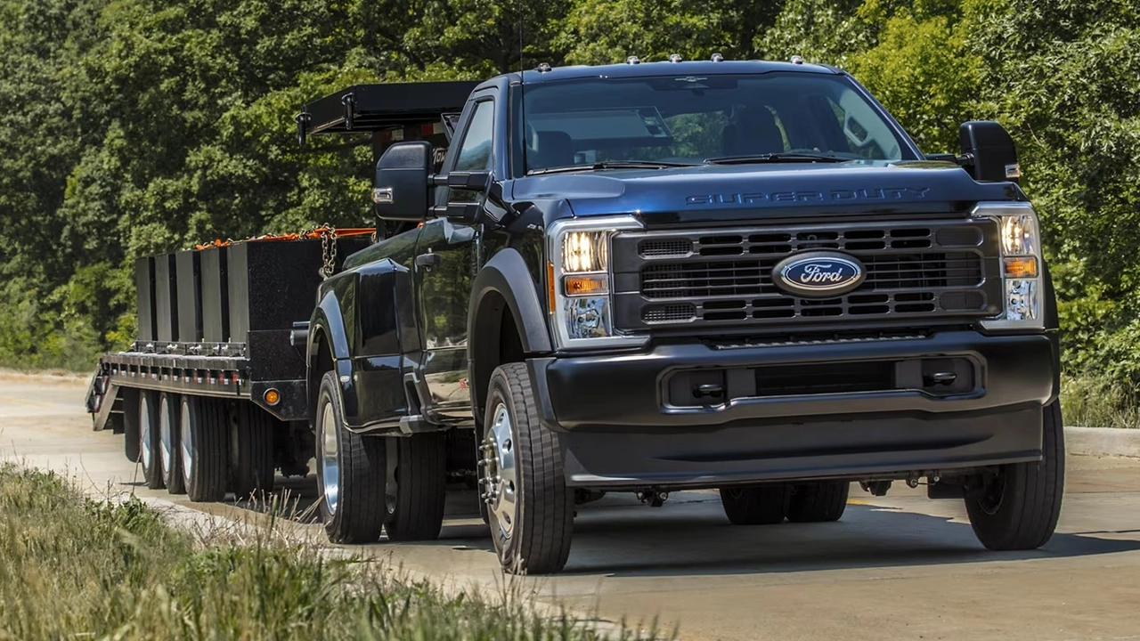 Vue 3/4 avant et latérale du Ford F-350 sur route tirant une remorque à plateforme